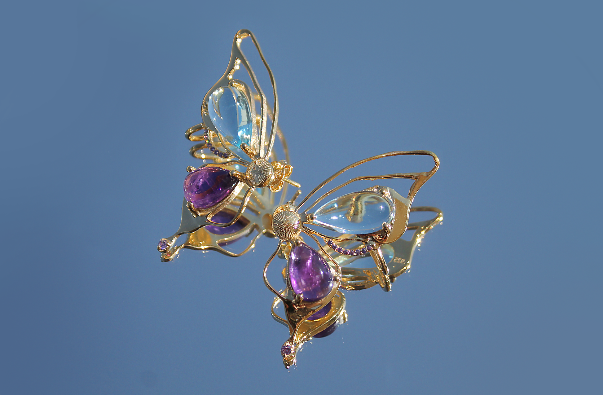 Gold plated butterfly earrings in 92.5 sterling silver, with natural amethyst and blue topaz stone. 